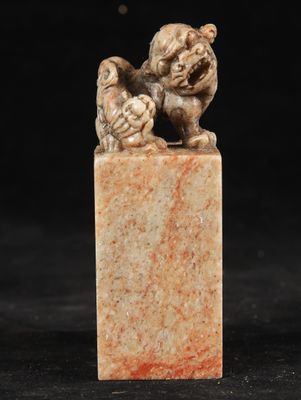 a chinese carved figurine of a dog and a bird on a marble block