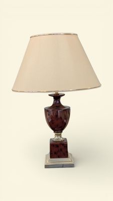 a lamp that is sitting on a table with a lamp shade on it