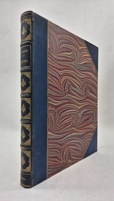 an old book with a blue cover and gold writing on it