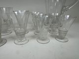 a lot of glasses and a pitcher on the table