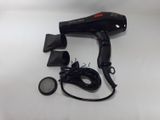 a black blow dryer sitting on top of a white table