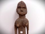 a wooden statue with a tag on it ' s chest