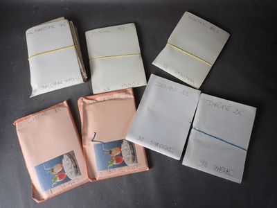 several pieces of paper sitting on top of a table next to each other