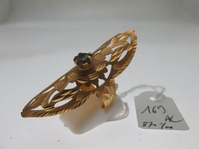 une broche en or ornée d'une pierre verte