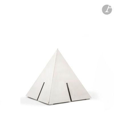 a small white pyramid shaped object on a white surface