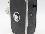an old black camera with a silver handle on a white background