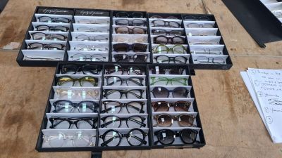 many pairs of glasses in a case on the table
