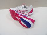 pair of white and pink tennis shoes sitting on a white surface