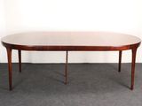 the table is made of wood and has a round top