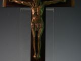 a statue of jesus on the cross in the corner of a room