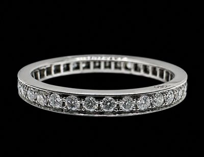 a close up of a diamond ring on a black background