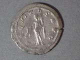an old silver coin with an image of a woman on it