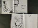 sketches of a man and a bear in a book on a table