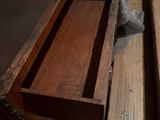 a wooden desk with a drawer on top of it