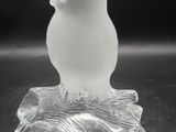 clear glass figurine of a bird sitting on a tree branch