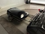 two motorcycles parked in a garage next to each other