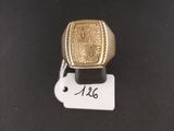 a close up of a gold ring on a black surface