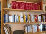 a bookshelf with many books on it in a room