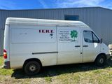 a white van that is parked in front of a building