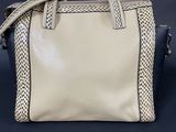 an image of a white and black handbag on a blue background
