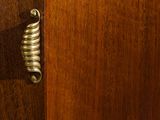 a close up of a door handle on a wooden door