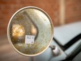 a close up of a car ' s rear view mirror with a sticker on it