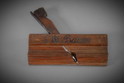 an old wooden box with a knife on top of it