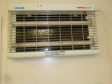 a picture of a wall mounted heater with a remote control