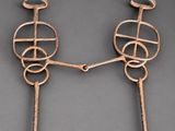 a pair of iron sculptures of a man and a woman holding hands