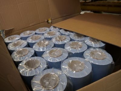 many rolls of toilet paper in a cardboard box