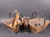 two wooden birds are sitting in a basket on a table