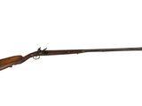 un fusil avec un canon en bois sur fond blanc