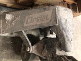 a wooden cart that is sitting under a pile of wood