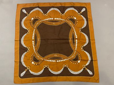 an image of a brown and white banda with a design on it