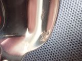a close up of a person ' s hand holding a silver spoon