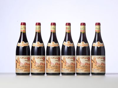 six bottles of red wine lined up in a row