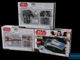 three star wars action figures sit on top of each other