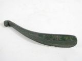 an old green metal object on a white surface with a white background