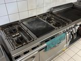 a kitchen with a stove, oven, sink and dishwasher in it