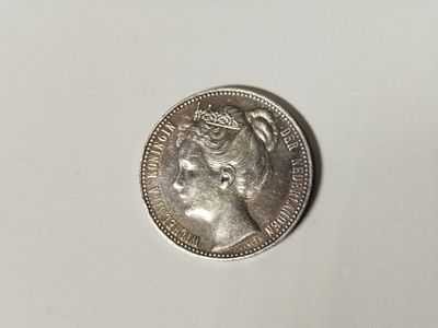 a close up of a silver coin with a woman ' s face on it
