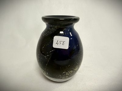 a black vase with a tag on it sitting on a table