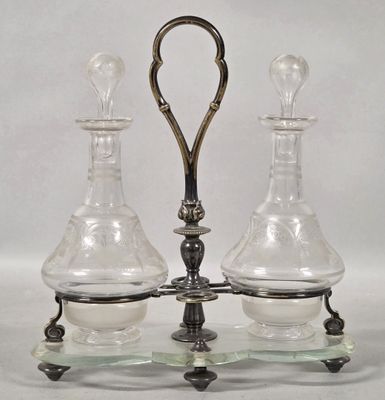 two glass vases on a metal stand with a handle