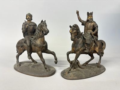 pair of bronze figurines of two men riding horses