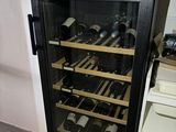 a wine cooler that has many bottles of wine in it