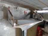 a metal shelf that has been placed on a concrete wall