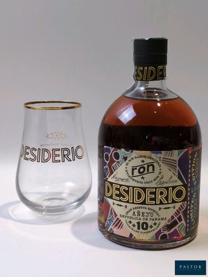a bottle and a glass sitting next to each other on a table