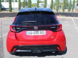 the rear end of a red toyota c - hr parked in a parking lot