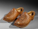 pair of leather shoes with a fish motif on the sole
