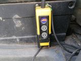 a yellow and black device sitting on top of a black box