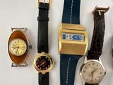 several different types of watches are lined up on a white surface